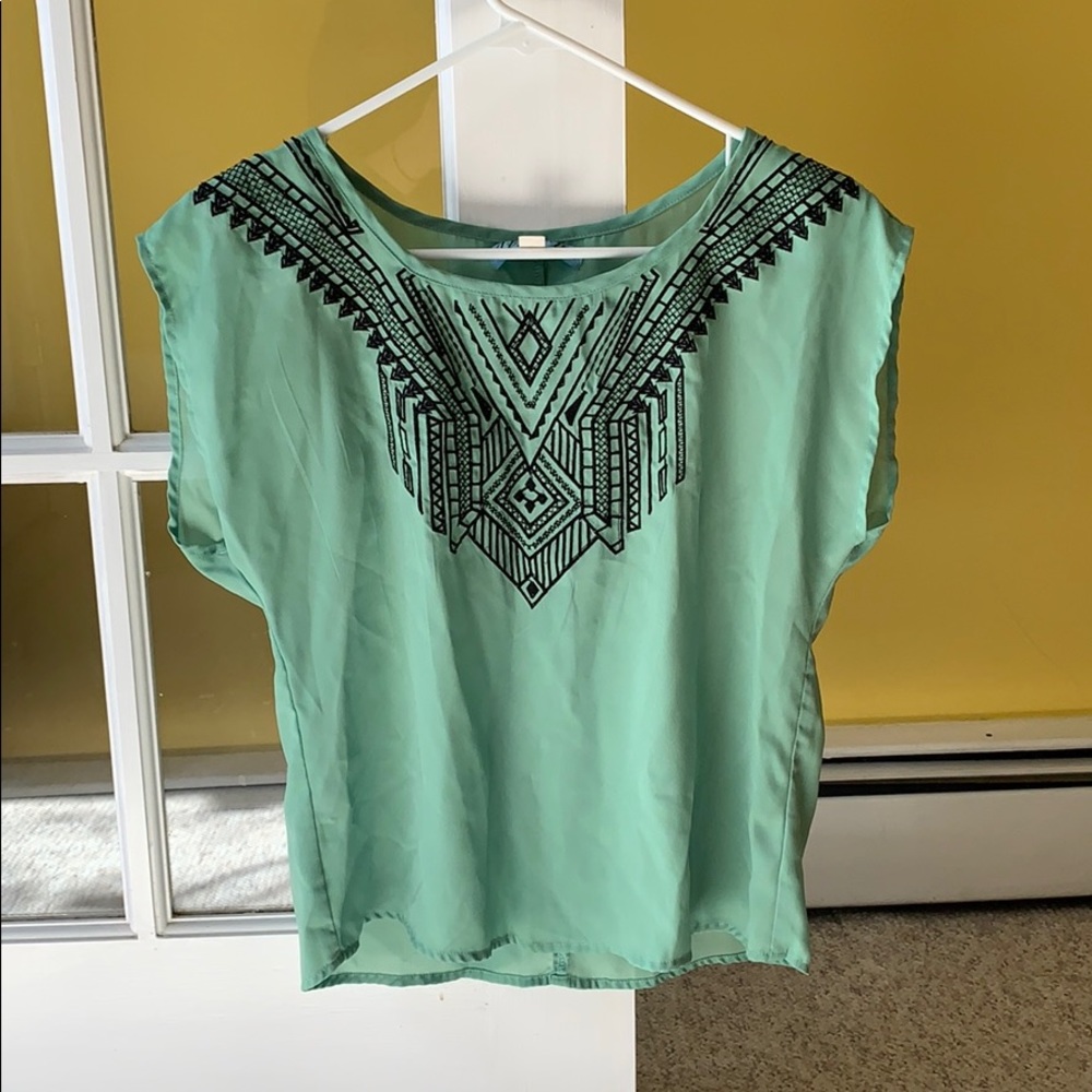 Francesca’s green top with black embroidery